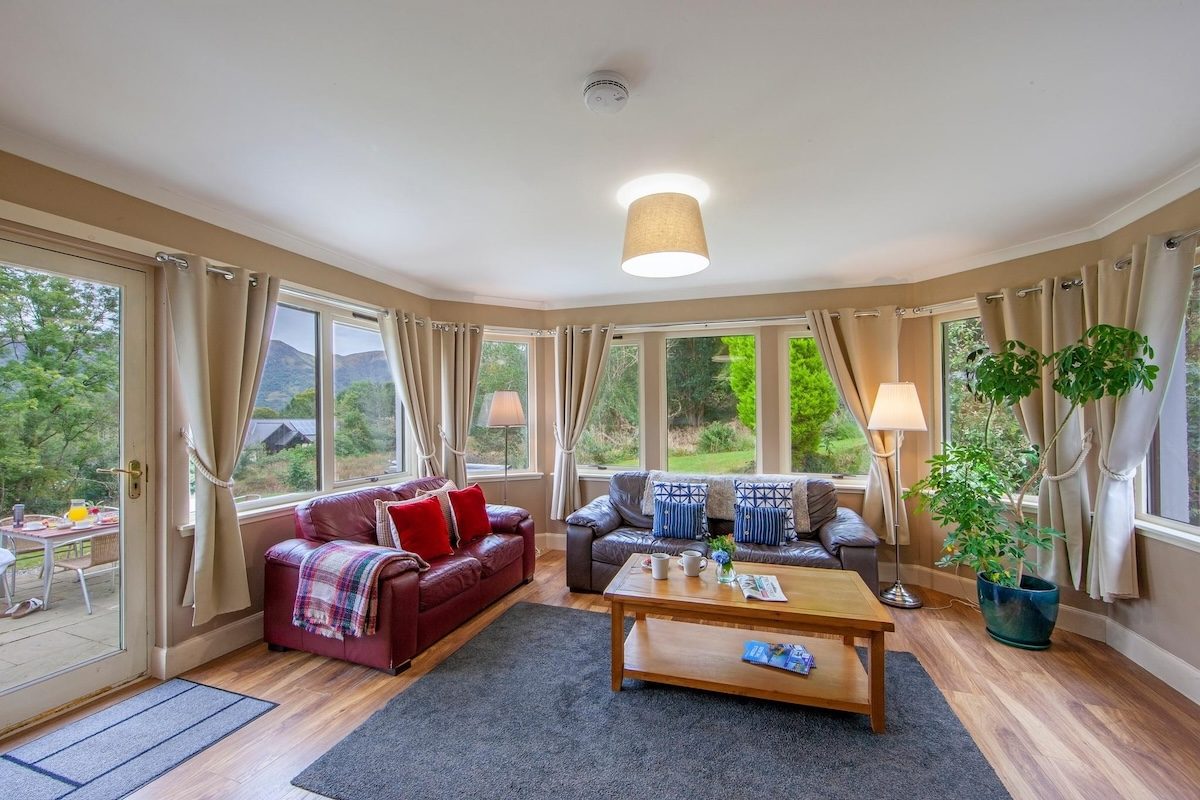 The living room at Wildwood with its bay window over the garden
