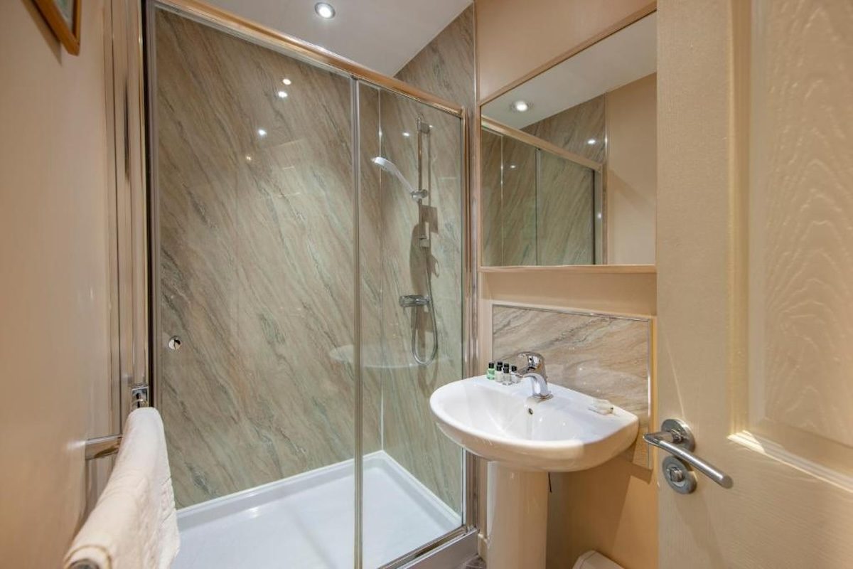 A family bathroom with bath and shower at Wildwood