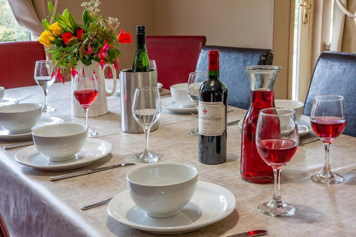 The dining table set with wine and flowers