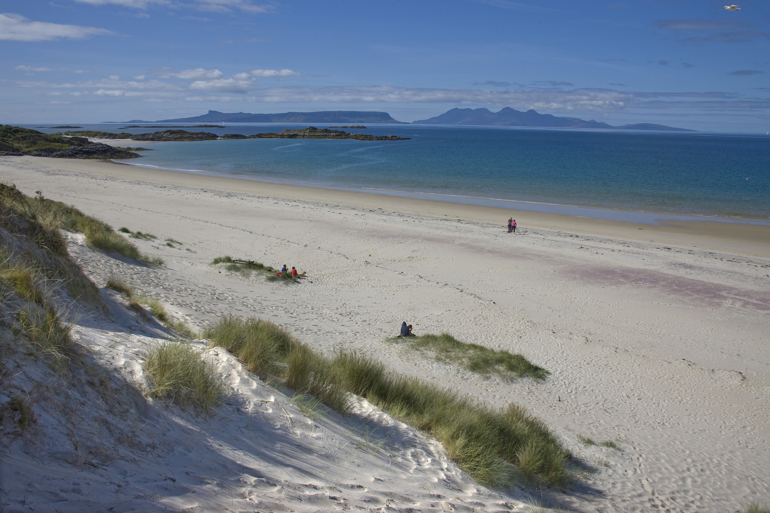 White sands and the island of Eigg beyond, on the road to the isles